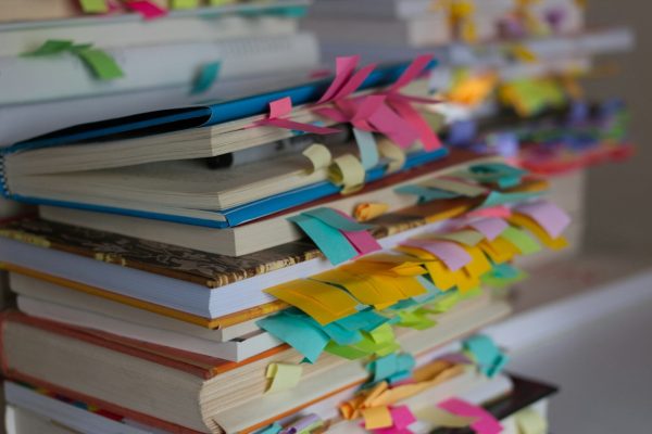a stack of books with colorful ribbons on them
